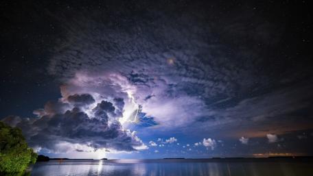 Majestic Twilight Lightning Over Calm Lake wallpaper
