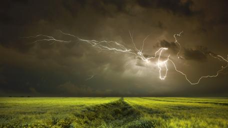 Electric Fury Over Verdant Plains wallpaper