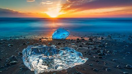 Serene Ice at Sunset Over the Ocean Coastline wallpaper