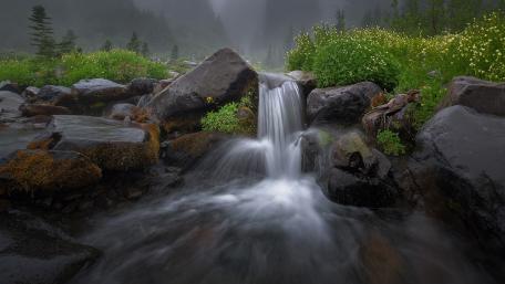 Serene Waterfall in Misty Landscape wallpaper