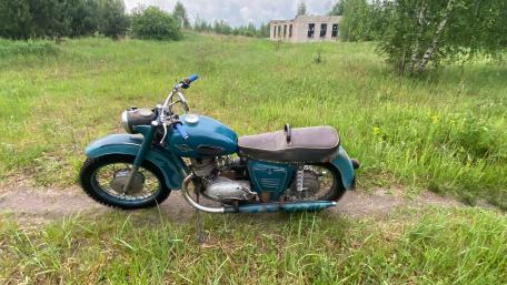 Retro Motorcycle in Serene Landscape Wallpaper wallpaper