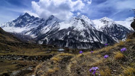 Majestic Mountain Range Under A Bright Sky wallpaper