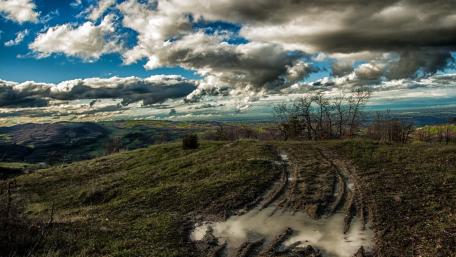 Majestic Cumulus Clouds Above Scenic Landscape wallpaper