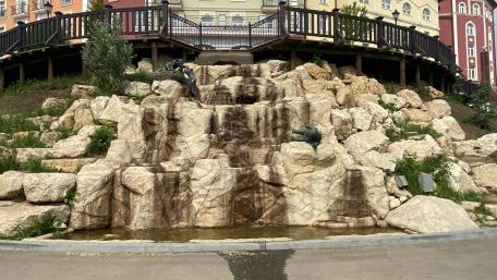 Serene Urban Waterfall Scene wallpaper