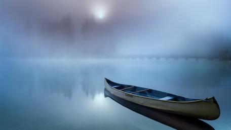 Serene Canoe on a Foggy Lake wallpaper