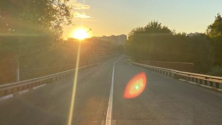 Sunrise Over Urban Roadway Brightening the Day Ahead wallpaper