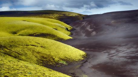 Lush Green Hills Under a Dramatic Sky wallpaper