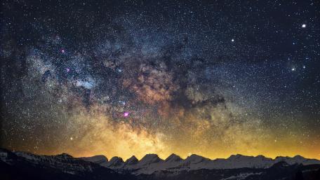Majestic Milky Way Over Mountain Peaks wallpaper