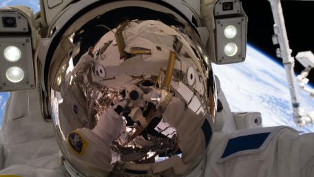 Astronaut Reflects on Earth from Space Station Viewpoint wallpaper
