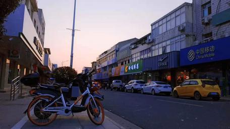 Evening City Street Scene with Cars and a Bike wallpaper