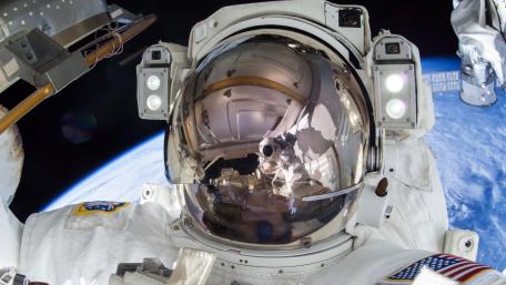 Astronaut in Space with Earth Reflected in Helmet wallpaper