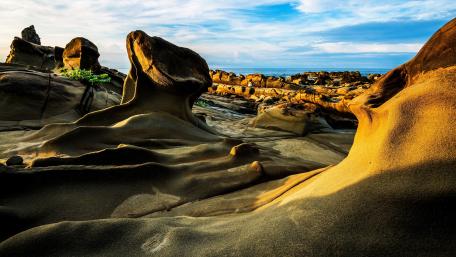 Majestic Rocky Landscape Under Bright Sky wallpaper