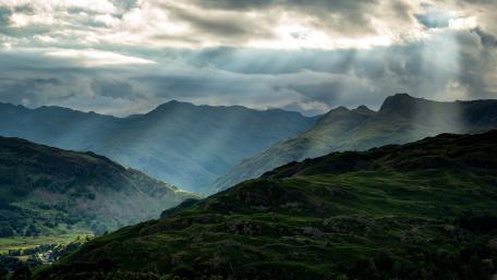 Majestic Sunlit Mountainscape wallpaper