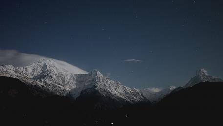 Majestic Snow-Capped Peaks Under a Starry Sky wallpaper