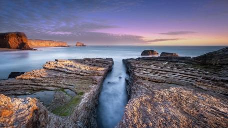 Serene Cove at Dusk Under Tranquil Skies wallpaper