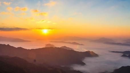 Breathtaking Foggy Sunset Over Mountain Range wallpaper