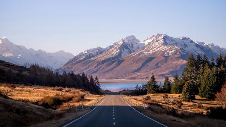 Serene Mountain Road Underneath Clear Sky wallpaper