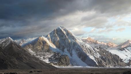 Majestic Mountain Range Under Dramatic Skies wallpaper