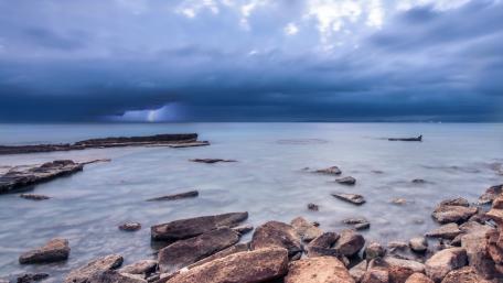 Stormy Horizon Over Tranquil Waters wallpaper