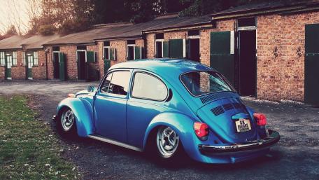 Classic Blue Volkswagen Beetle in Vintage Setting wallpaper