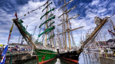 Majestic Sailing Ships in Harbor Scene wallpaper