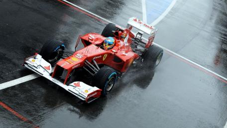 F1 Race Car in Action on Wet Track wallpaper