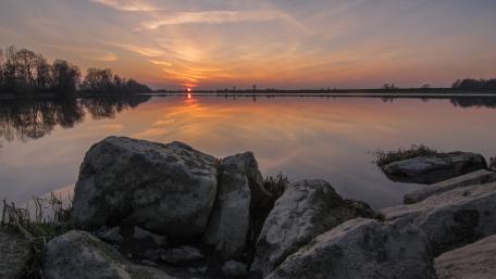Serene Sunset Over Tranquil Lake Waters wallpaper