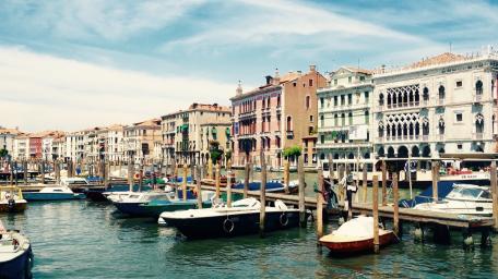 Serene City Harbor with Charming Boats and Colorful Buildings wallpaper