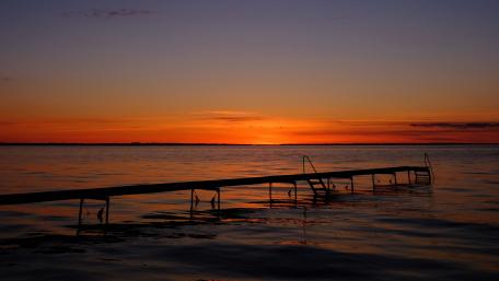 Pier on beach at sunset wallpaper