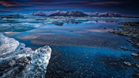 Mountains in lake with ice and snow wallpaper
