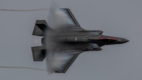 Stealth Predator Soaring Through Clouds wallpaper