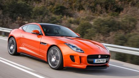 Dynamic Orange Sports Car on Open Road wallpaper