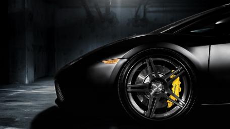 Sleek Black Car with Alluring Alloy Wheels wallpaper