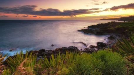 Serene Coastal Sunset Over Crystal Blue Waters wallpaper