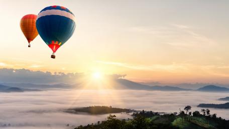 Serene Hot Air Balloon Adventure Above the Foggy Landscape wallpaper