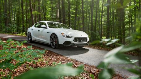 Sleek Maserati Ghibli in Serene Forest Setting wallpaper