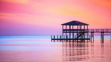 Serene Sunset Over Tranquil Pier View wallpaper