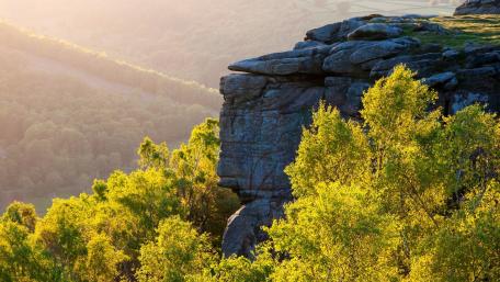 Majestic Cliff Overlooking Lush Valley wallpaper