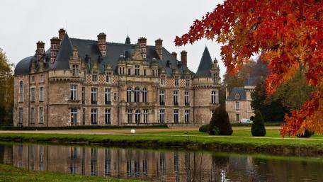 Majestic Castle Reflected in Autumn Waters wallpaper