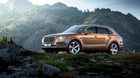 Luxury SUV in Majestic Mountain Landscape wallpaper