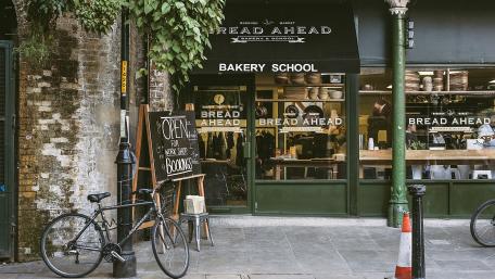 Quaint City Bakery with Bicycle Charm wallpaper