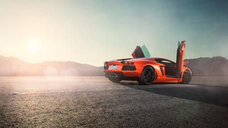 Orange Lamborghini Aventador in Open Desert Road wallpaper