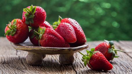 Fresh and Juicy Strawberries on a Wooden Plate wallpaper
