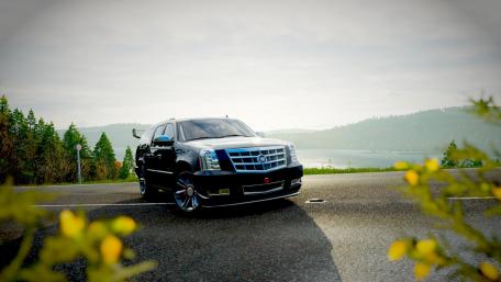 Sleek Black Luxury SUV by the Lake wallpaper