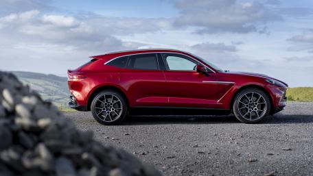 Sleek Aston Martin DBX on a Scenic Driveway wallpaper