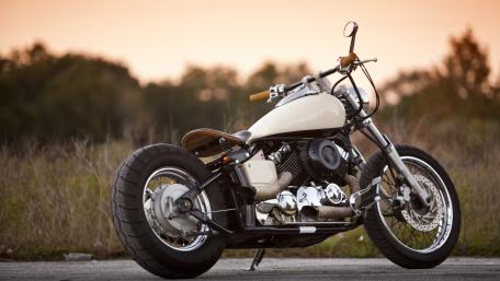 Sleek Custom Motorcycle Bathed in Sunset Glow wallpaper