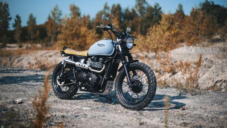 Classic Triumph Motorcycle in Nature's Embrace wallpaper