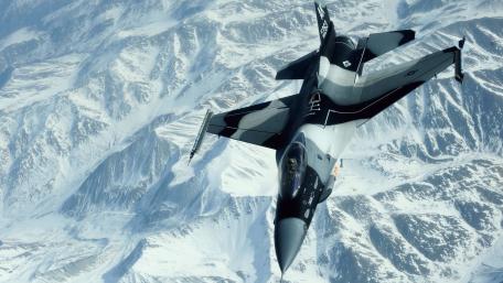 Stealth in the Skies Above Snowy Peaks wallpaper
