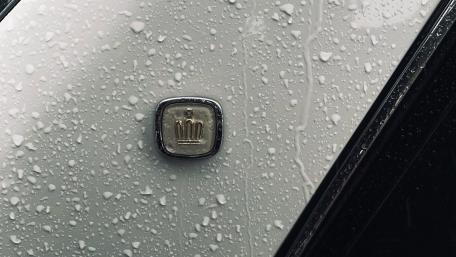 Elegant Toyota Crown Emblem in Rainy Setting wallpaper