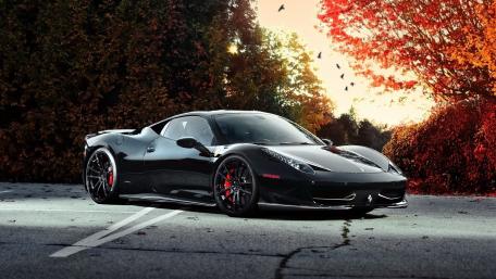 Sleek Black Ferrari 458 in Vibrant Autumn Scene wallpaper